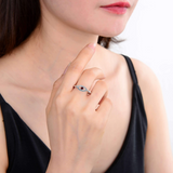 Evil eye ring on model, model wearing garnet ring, red gemstone ring on women
