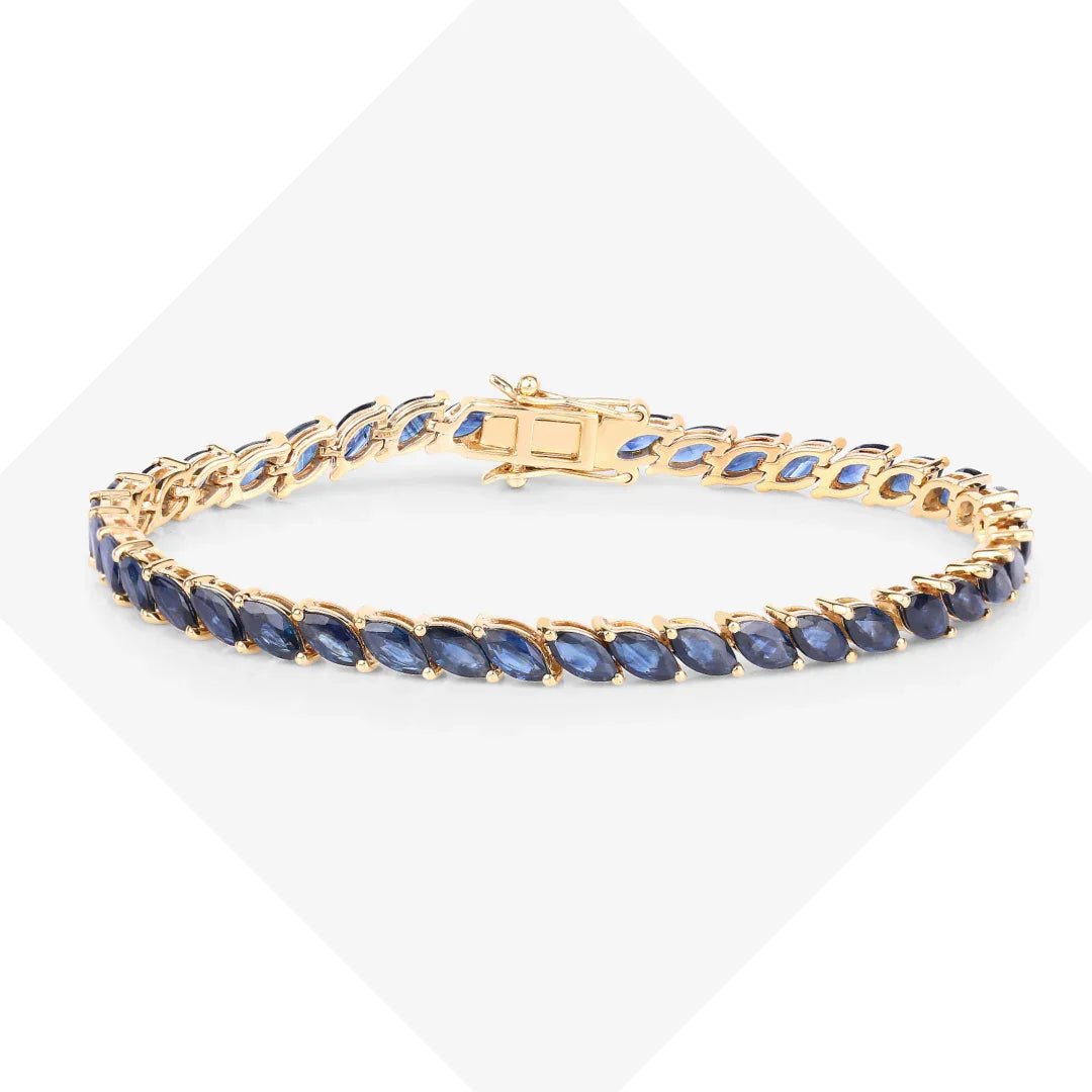 A genuine blue sapphire bracelet with a yellow gold tennis chain and box clasp.