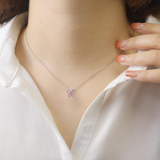 elegant pendant design, minimal jewelry designs, ruby butterfly pendant on model, model wearing ruby jewelry