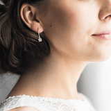 model showcasing  White Topaz Hoop Earrings  Rhodium Plated Silver Earrings Gift for Her