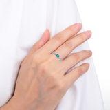 Model wearing emerald ring, model wearing green gemstone ring
