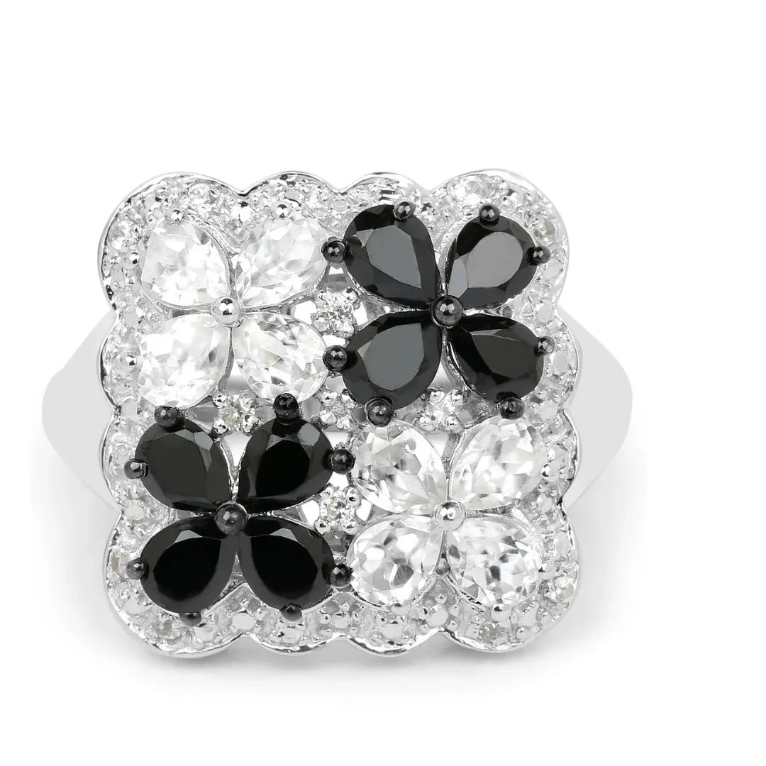 Anillo floral con espinela negra y topacio blanco