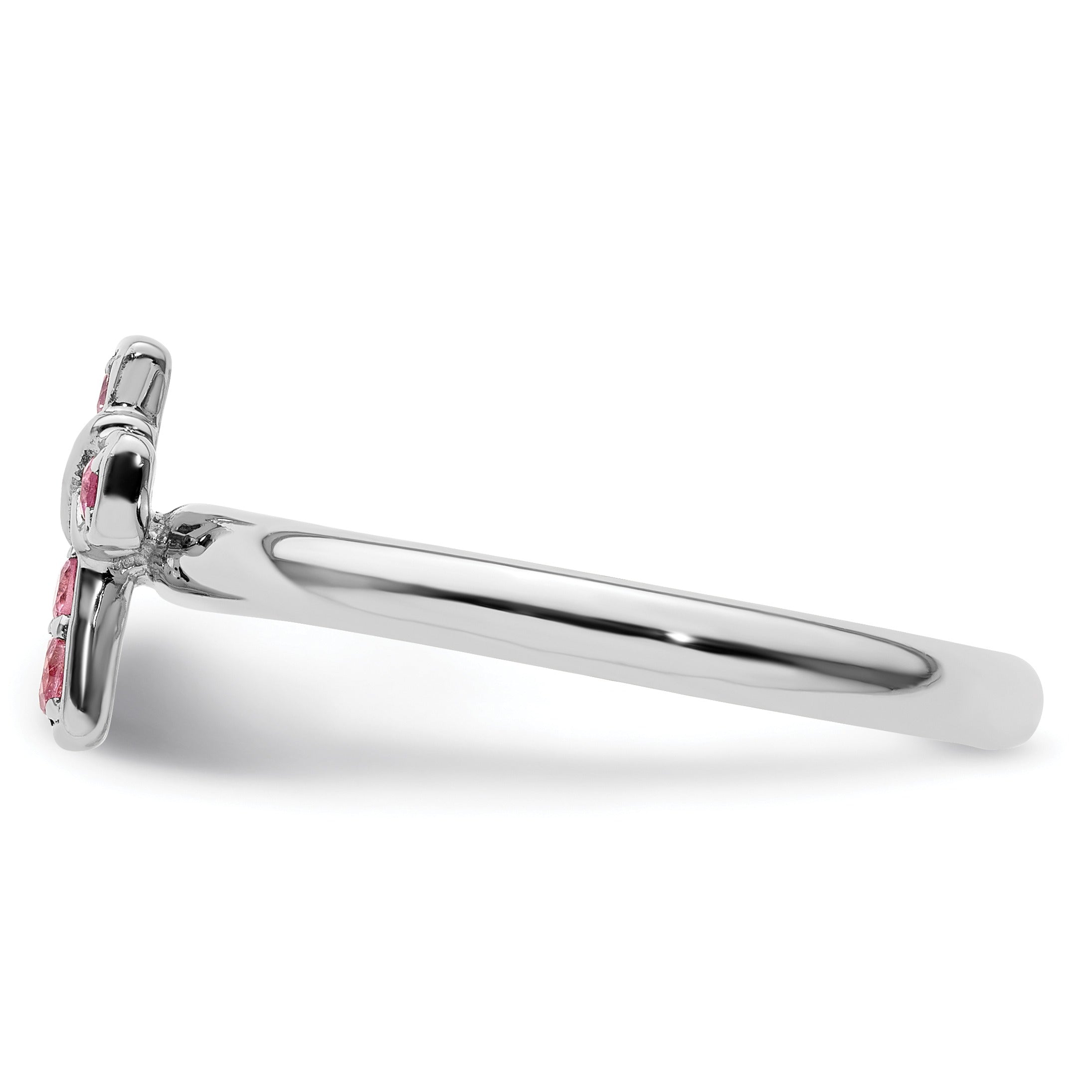 Side view of silver ring band with pink gemstone flower design on white background