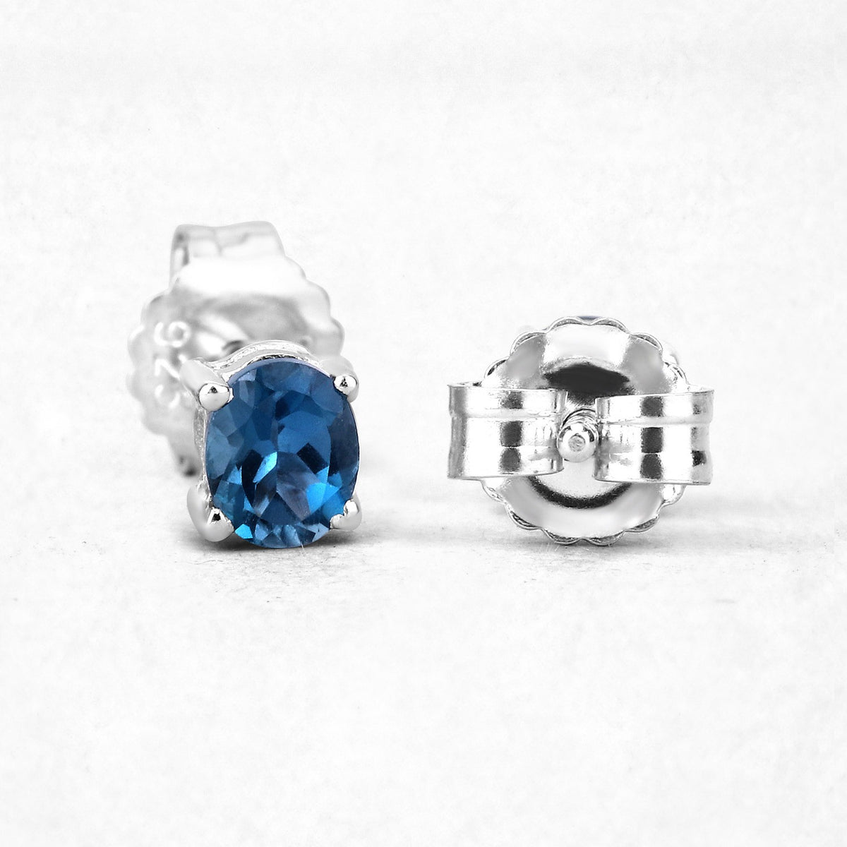 0.80 Ct Oval Blue London Blue Topaz Sterling Silver Rhodium-Plated 4 Prong Stud Earrings