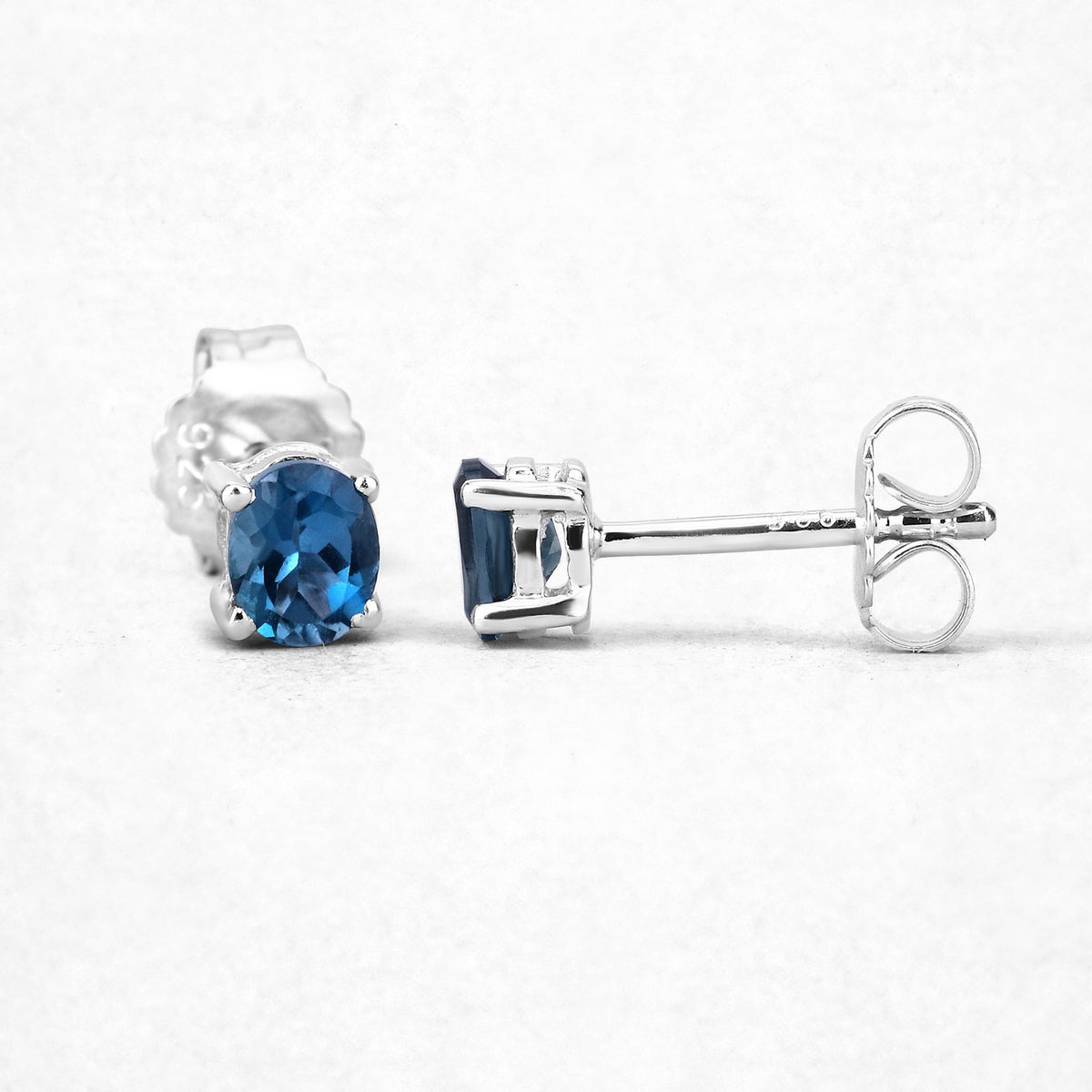 0.80 Ct Oval Blue London Blue Topaz Sterling Silver Rhodium-Plated 4 Prong Stud Earrings