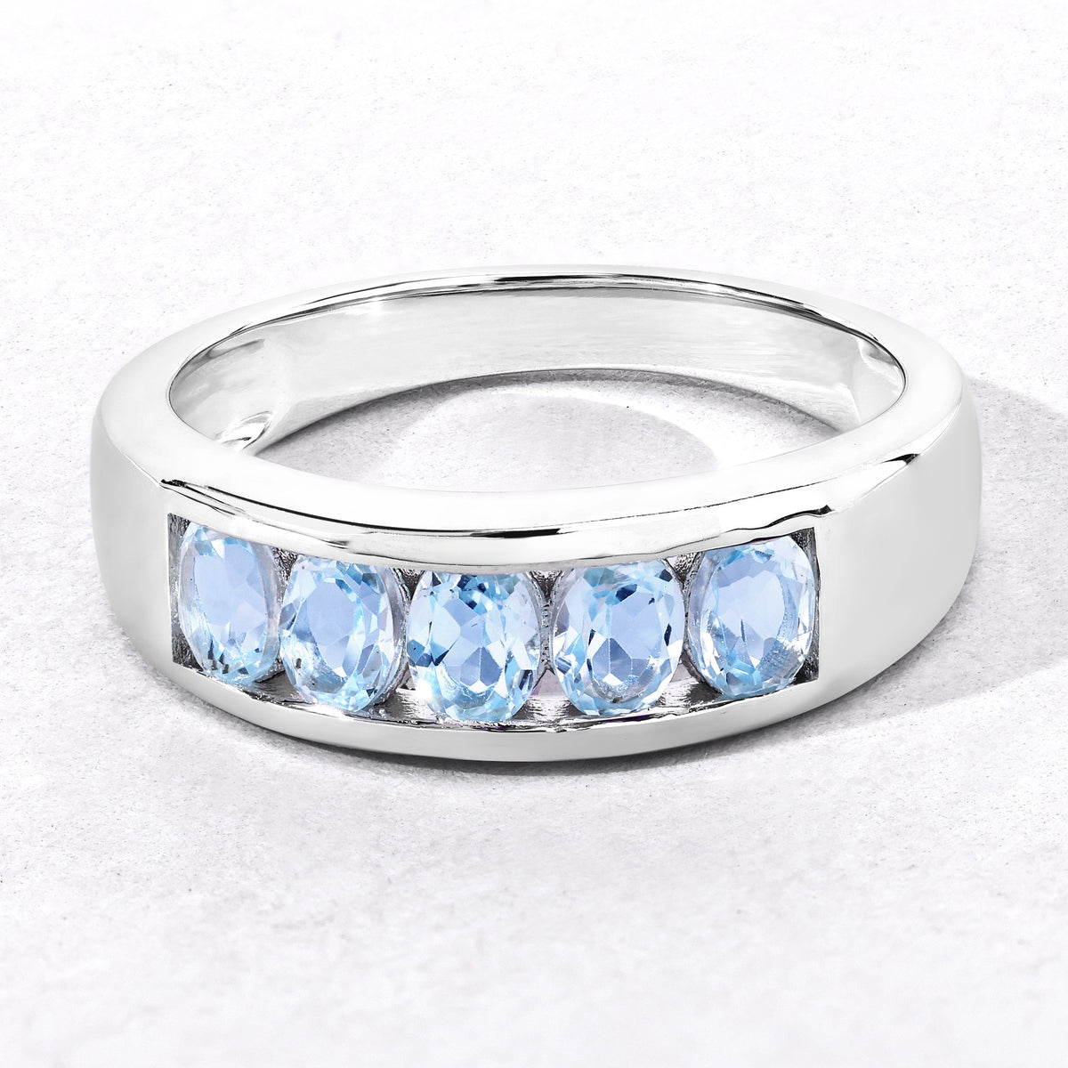 0.95 Cttw Oval Light Blue Topaz Channel Rhodium over Silver Five Stone Ring