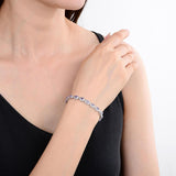 Elegant model hand showcasing the intricate details of our silver bracelet Sterling Silver Oval Tanzanite Bracelet