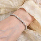 Elegant model hand showcasing the intricate details of our Tennis Moissanite Bracelet,silver bracelet