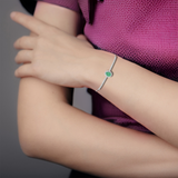 Elegant model hand showcasing the intricate details of our Green Bracelet Oval Emerald Bracelet for Women