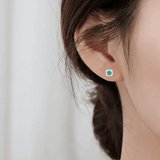 Model showcasing Genuine Emerald Halo Earrings with Moissanite Accents Silver Stud Earrings 