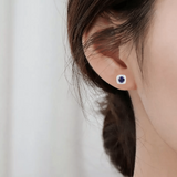 Model showcasing Natural Sapphire Halo Earrings With Moissanite Accents White Gold and Light Blue Halo Stud Earrings Affordable Sapphire Jewelry Gift For Her