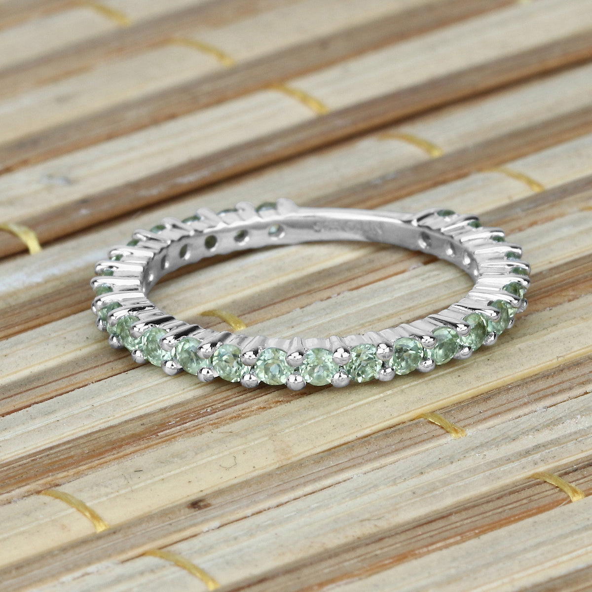 0.91 Ct Round Light Green Peridot Rhodium Over 925 Sterling Silver Eternity Band Ring