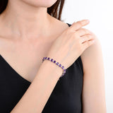hand showcasing the Sterling Silver Amethyst Bracelet,  $ 200 - 300, Amethyst, Oval, Purple, 925 Sterling Silver, Tennis